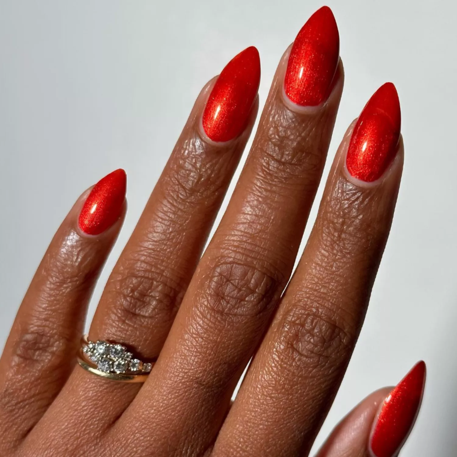 Close up of sparkly apple red nails