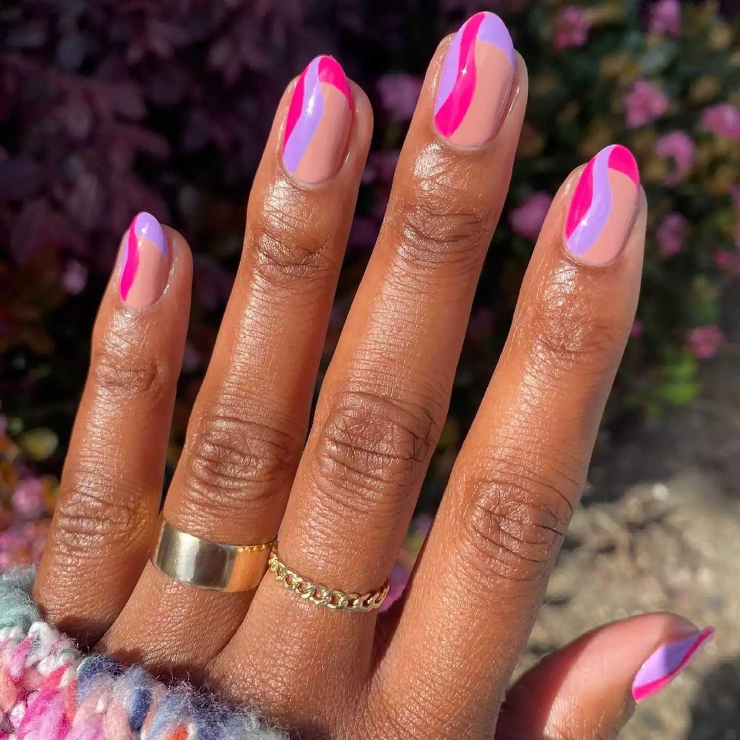 Pink and purple squiggle nails with French tips and nude details