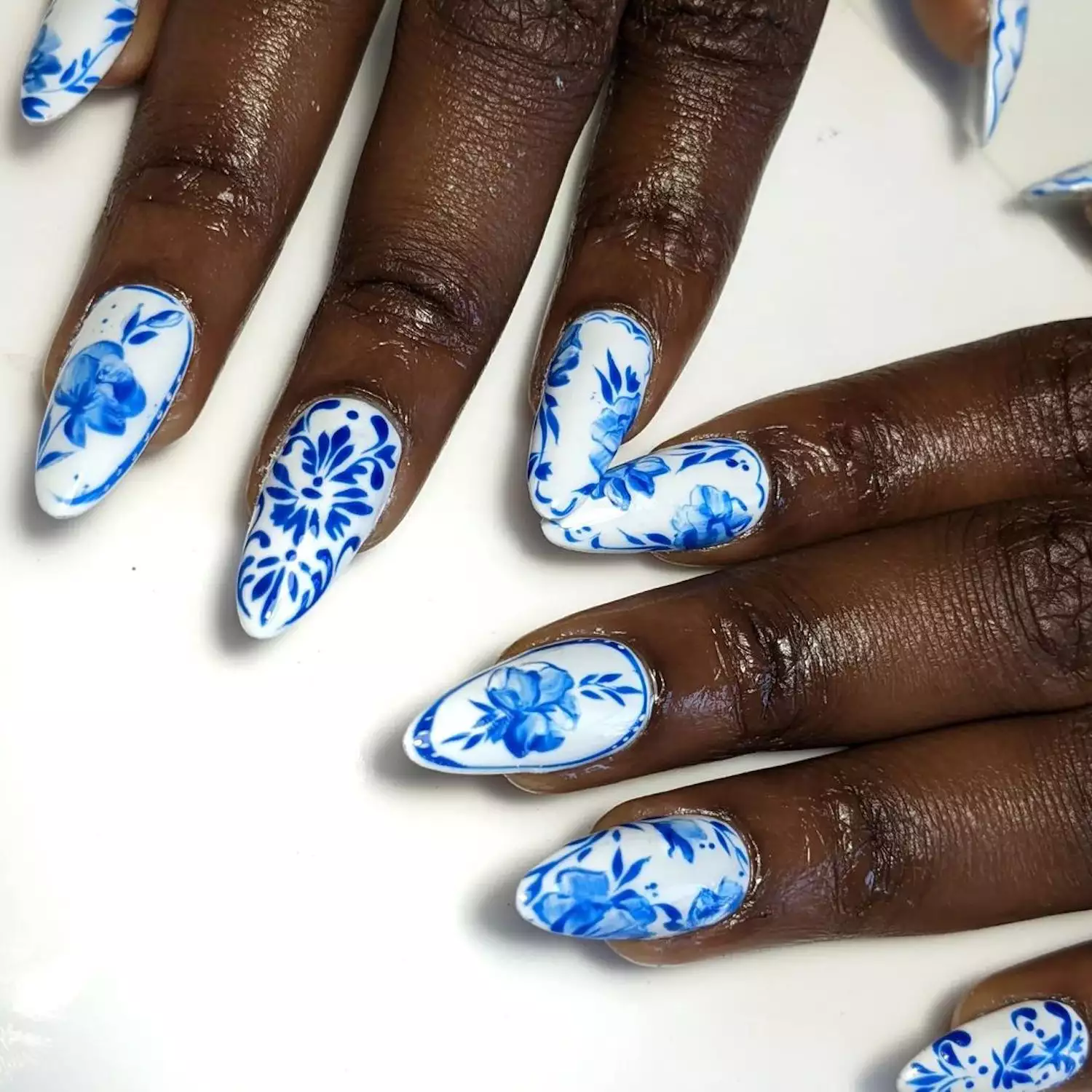 White nails with a blue porcelain design