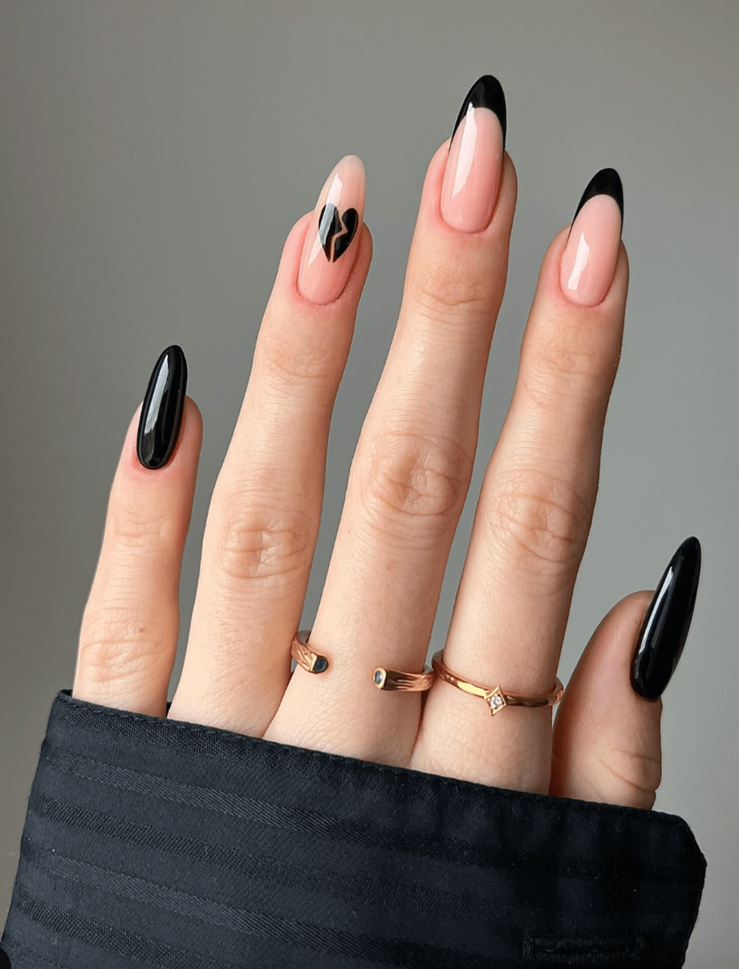 Black French tips with broken heart designs