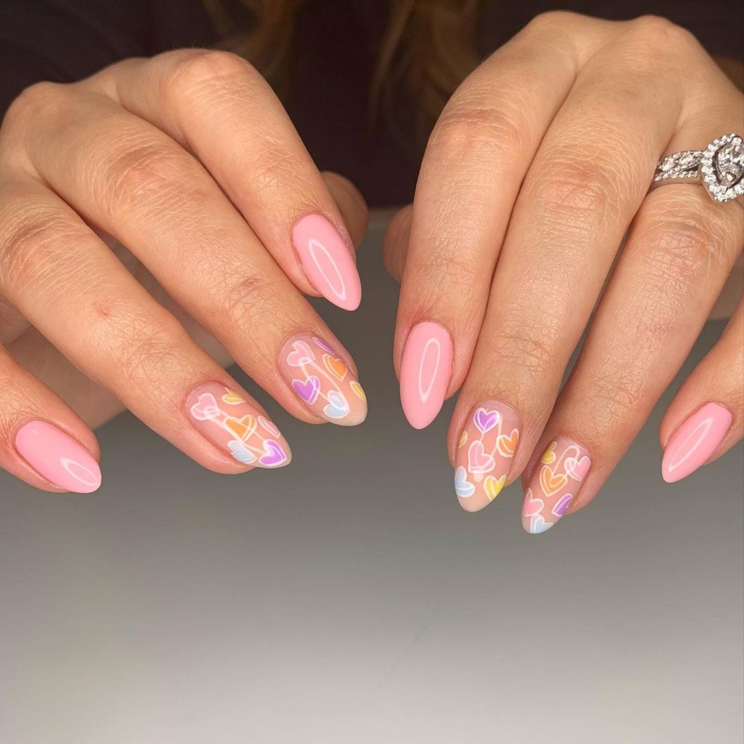 Light pink nails with pastel candy heart designs