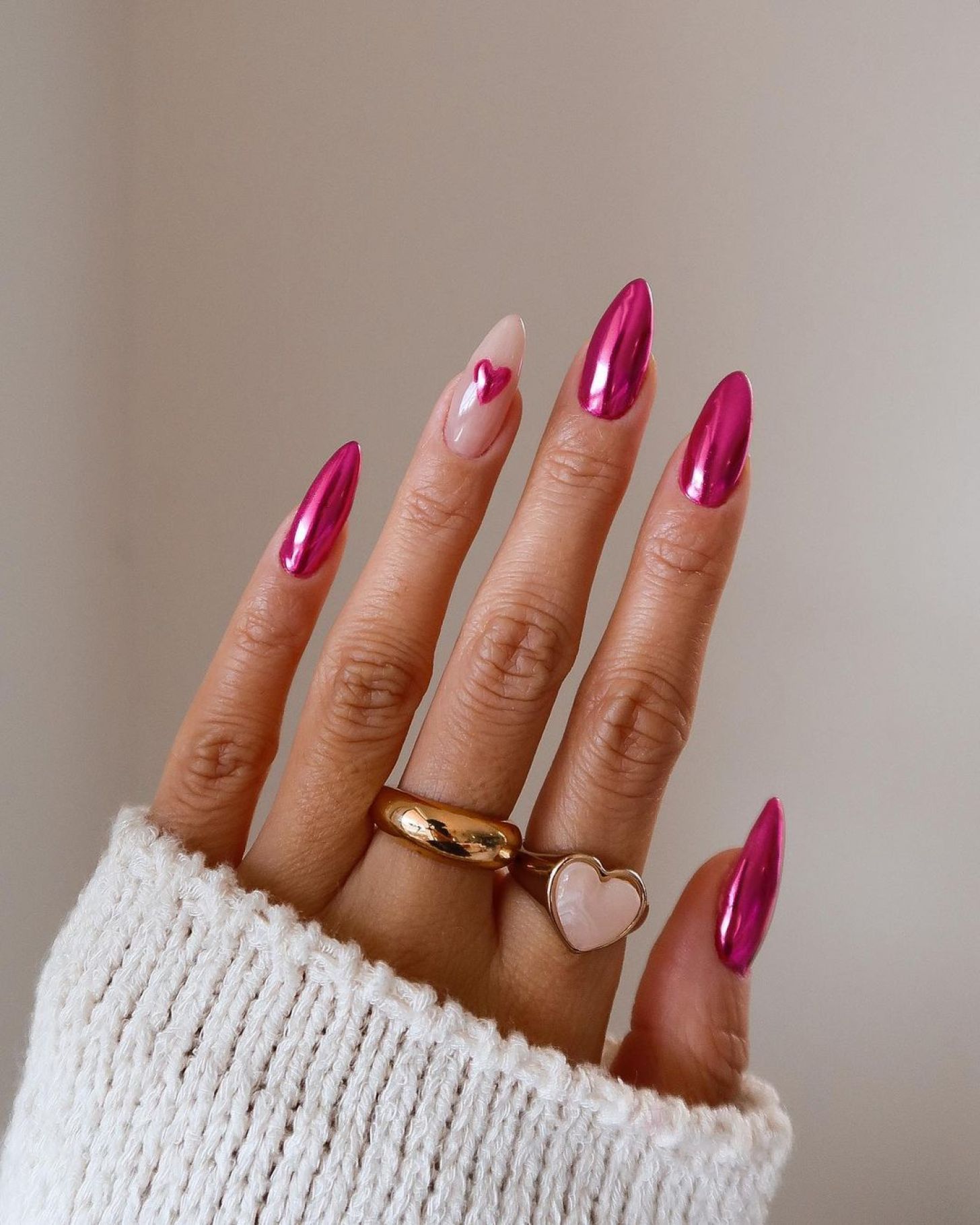 cute metallic bright pink simple Valentine's Day nails with heart accent designs on one finger