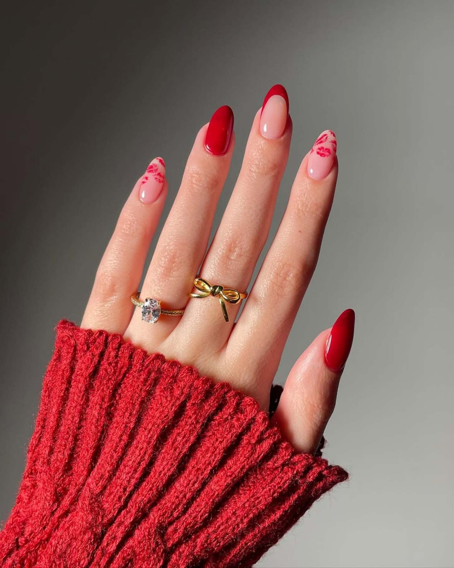 cute red Valentines Day nails with simple french tip designs and red lip nail art on two fingers