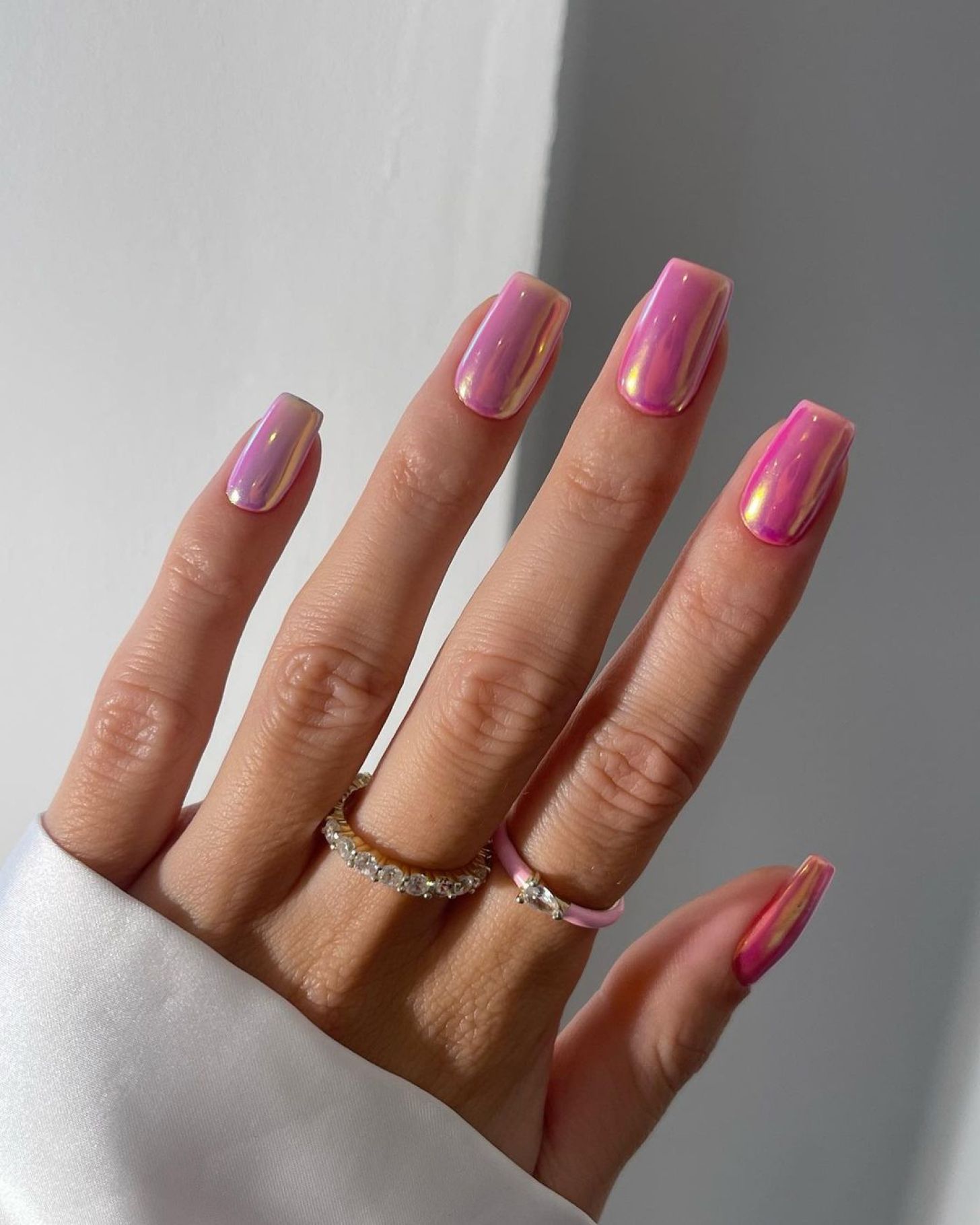 Shimmery metallic pink nails in a square shape