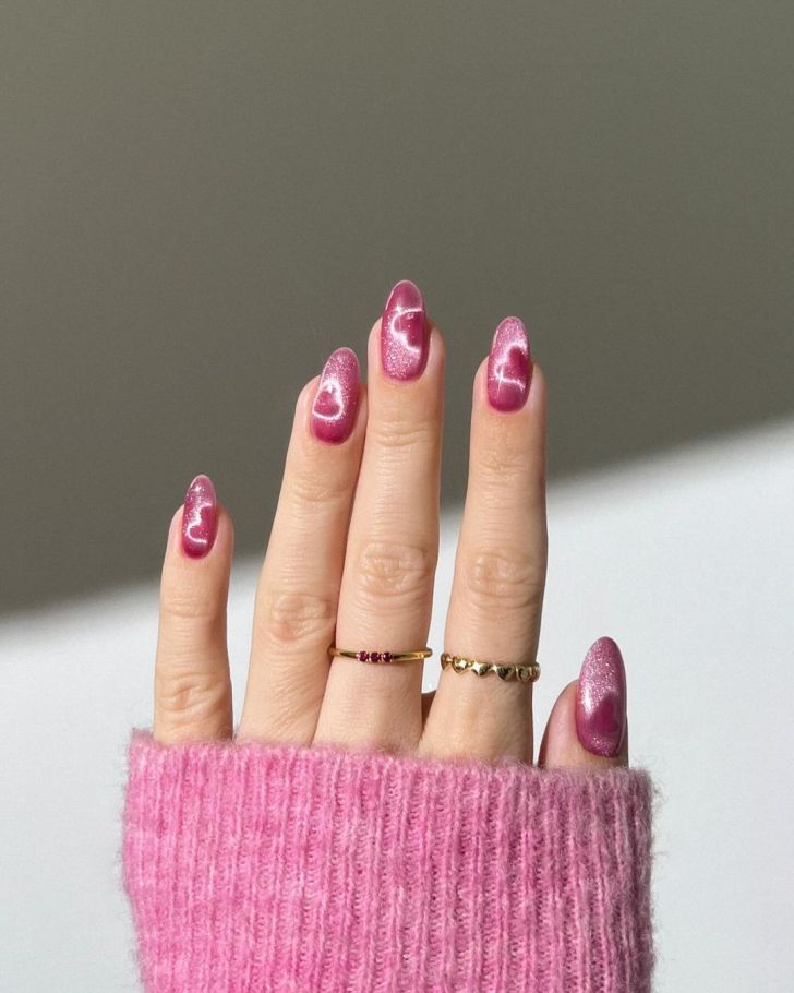 simple glittery Valentine's Day nails with pink polish colors and holographic heart art designs