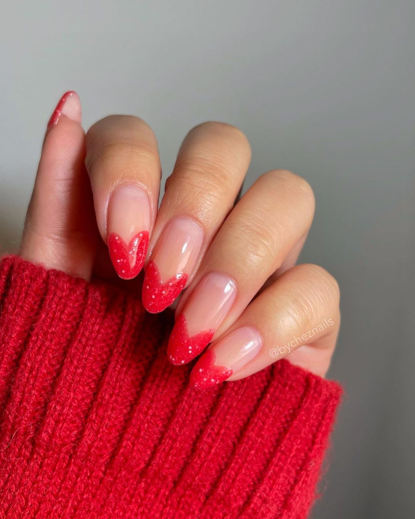 cute and simple Valentine's Day nails with glitter red heart-shaped tips