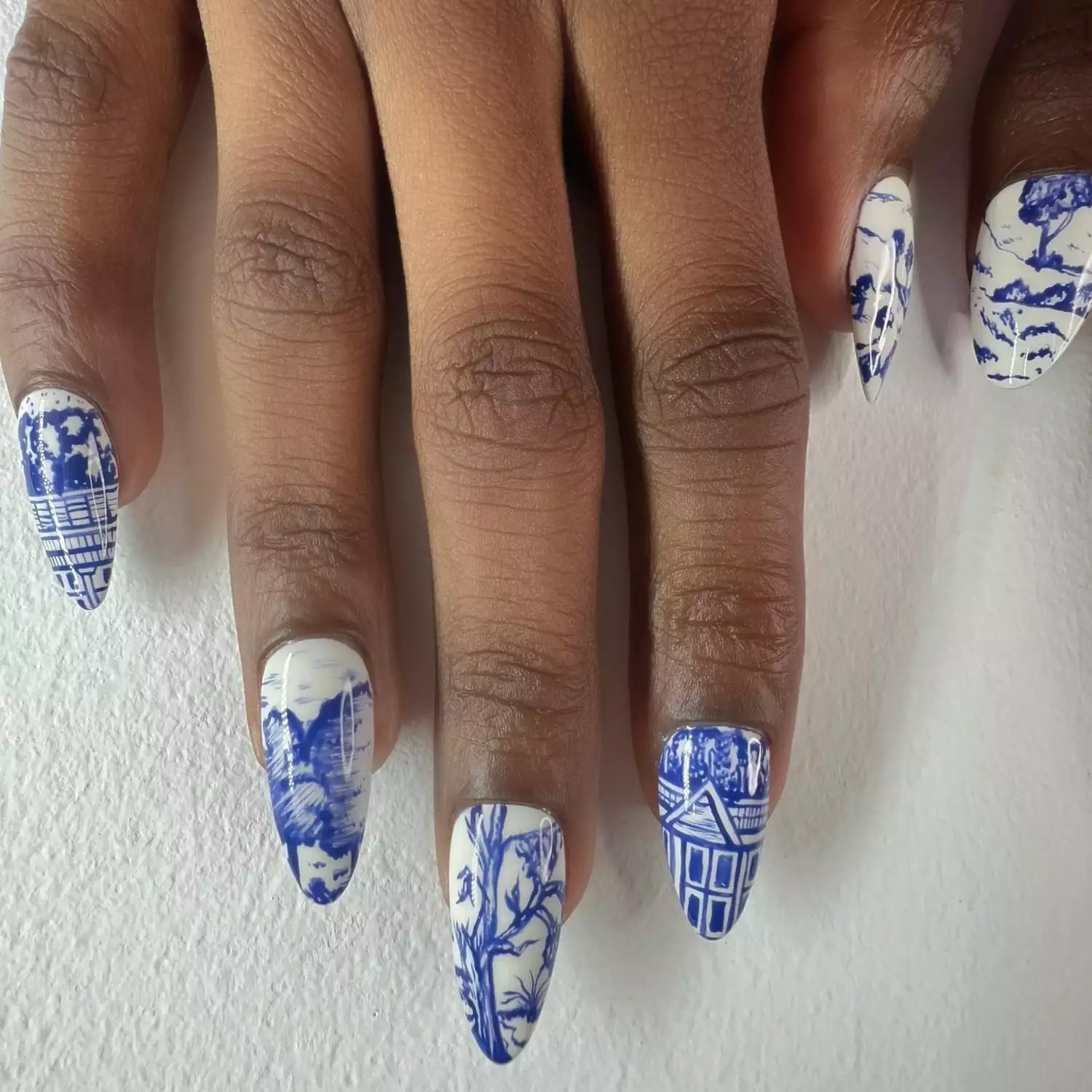 Cobalt blue painted trees, towns, and landscape on white nails