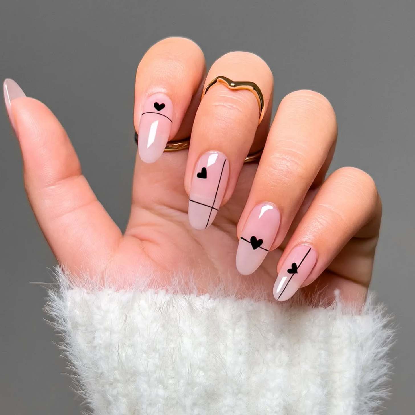 Sheer nails with black line art and heart designs