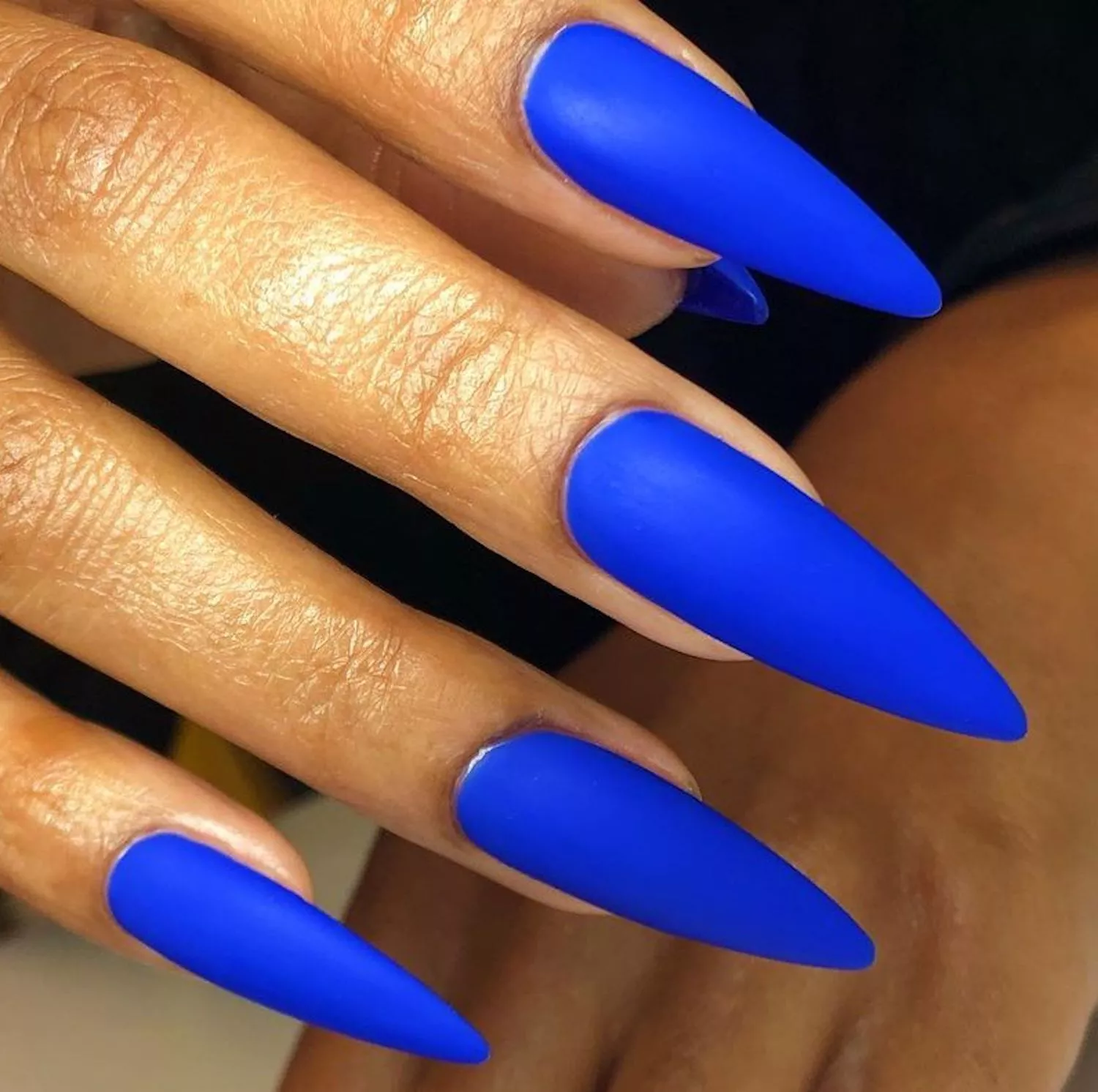 Long, almond-shaped nails in a royal blue